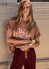 THE UPSIDE women’s brown 100% organic cotton Jacob Tee is designed for an oversized fit and features a ribbed collar and printed logo detail. Made for lifestyle.