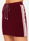 THE UPSIDE women's maroon organic cotton Zelma Knit Mini Skirt is a true to size fit with contrast side stripe detailing and an adjustable drawcord waist. Made for lifestyle.