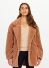 THE UPSIDE women’s brown recycled polyester Gracie Teddy Coat is a relaxed fit mid length coat and features a double breasted closure, welt pockets and faux shearling fabrication. Made for lifestyle.