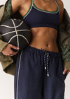 THE UPSIDE women's navy Rhythm Faye Racerback Bra is designed for a supportive and comfortable fit and features a scooped neckline, T-bar back and built in shelf bra with removable cups. Made for pilates.