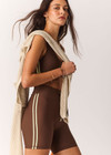 THE UPSIDE women's brown Daytona 5inch Spin Short offers a soft and supportive fit with a mid rise waist, contrast side binding and adjustable drawcord. Made for yoga and pilates.