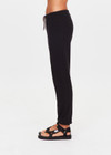 THE UPSIDE women's black organic cotton Kayne Track Pant is a classic mid-rise track pant and features a soft elasticated waistband with a brown paracord drawcord, elasticated cuffs and finished with a subtle embroidered arrow logo at back. The perfect everyday track pant, made to last.