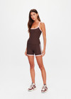 THE UPSIDE women's chocolate Rhythm 5inch Spin Short is mid-rise and features cream and light green binds along side seams in our recycled rib fabrication. Made for yoga and pilates.