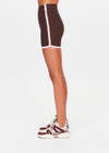 THE UPSIDE women's chocolate Rhythm 5inch Spin Short is mid-rise and features cream and light green binds along side seams in our recycled rib fabrication. Made for yoga and pilates.