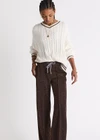 THE UPSIDE women's cream Millie V Neck Knit Sweater is designed for a relaxed fit and features a high v neckline and chocolate metallic stripes along cuffs, neckline and hem. Made for lifestyle.