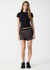 THE UPSIDE women's black Divina Isabella Baby Tee is designed for a soft and supportive fit in cotton modal fabrication and features a printed logo arrow in cream. Made for lifestyle.