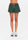 THE UPSIDE women’s green Billie Run Short is a mid-rise style featuring cream mesh binding down the sides and an orange drawcord. Made for high impact.