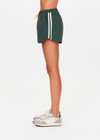 THE UPSIDE women’s green Billie Run Short is a mid-rise style featuring cream mesh binding down the sides and an orange drawcord. Made for high impact.