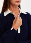 THE UPSIDE women's navy organic cotton Wonder Knit Polo is designed for a relaxed fit and features long sleeves with a contrast cream collar and placket. Made for lifestyle.