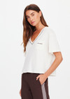THE UPSIDE women’s natural Elina V Neck Tee is a boxy-fit style featuring a mini chest patch pocket and ribbed neckline with chocolate piping. Made for lifestyle.