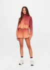 THE UPSIDE women's red Maya Ace Shell Jacket is designed for a cropped fit and features water-resistant, moisture-wicking, quick-dry fabric with four-way stretch. Made for running.