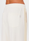 THE UPSIDE women's natural recycled polyester Roma Pant is high rise and features a butter mesh tape along side seams and back pockets with a logo pip. Made for lifestyle.