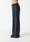 THE UPSIDE women's stripe Wool Elita Pant is a mid-rise, wide leg pant and features cream piping along side seams and maroon paracord drawcord. Made for lifestyle.