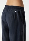 THE UPSIDE women's stripe Wool Elita Pant is a mid-rise, wide leg pant and features cream piping along side seams and maroon paracord drawcord. Made for lifestyle.