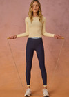 THE UPSIDE women's navy recycled nylon Hermosa 25 Inch Pocket Legging is mid rise and features a contrast hem cuff in butter and pockets at the side. Made for yoga and pilates.