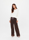 THE UPSIDE women's chocolate metallic Galaxia Loretta Wide Leg Pant is a mid to low rise fit with pin tuck and features an elasticated waistband, a purple paracord drawcord and side seam pockets. Made for lifestyle.