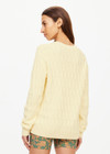 THE UPSIDE women's butter yellow Boo Cable Knit Sweater is made with organic cotton and features a patch pocket at chest and ribbed cuff, neck, and hem.