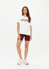 THE UPSIDE women's white Alumni Jodhi Tee is made with organic cotton jersey and is designed with a classic crew neck shape with a logo across the chest.