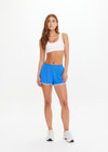 THE UPSIDE women's blue 70s style Wrangler Callie Run Short is made from recycled mesh fabric and features an internal short, elastic waist and side pockets.
