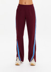 THE UPSIDE women's maroon Ryder Petra Flare Trackpant feature blue side stripes, a split hem, elasticated waist and side pockets.