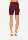 THE UPSIDE women's maroon Trail 6 inch Spin Short is made from soft, breathable fabric and features contrast butter yellow side stripe and an elastic waist.