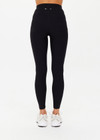 THE UPSIDE women's Peached 25 Inch Pocket legging is a mid rise 7/8 length leg in black with side pockets and a stretch drawcord waistband. The fabric is breathable and quick drying.