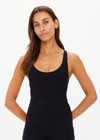 THE UPSIDE women's black recycled peached Laurie Tank Top provides mid coverage longline tank top with a scooped T bar back and internal underbust elastic and removable cups. The fabric is breathable and moisture wicking.