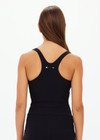 THE UPSIDE women's black recycled peached Laurie Tank Top provides mid coverage longline tank top with a scooped T bar back and internal underbust elastic and removable cups. The fabric is breathable and moisture wicking.