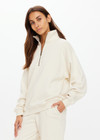 THE UPSIDE women's white organic cotton Hamilton Wren Half Zip Sweater is designed for a regular fit and features a embroidered horseshoe logo. Perfect for everyday.