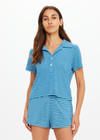 THE UPSIDE women's blue stripe Rio Lilou Polo top features a soft stretch terry fabrication with cropped polo shape and button front. The perfect vacation piece.