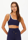 THE UPSIDE women's navy Silverstone Harley Scoop Sports Bra is designed for a supportive fit featuring a recycled rib fabrication and removable bust cups. Ideal for yoga and pilates.