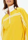 THE UPSIDE women's recycled fabric Prix Dawson Run Jacket in mimosa yellow is light and breathable whilst being water resistant and moisture wicking. Large back pocket with zip makes stow away and packing easy.