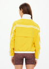 THE UPSIDE women's recycled fabric Prix Dawson Run Jacket in mimosa yellow is light and breathable whilst being water resistant and moisture wicking. Large back pocket with zip makes stow away and packing easy.