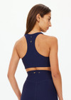 THE UPSIDE women's navy recycled peached Daytona Jetta Racerback Sports Bra is designed for a supportive fit and features removable cups. Made for yoga & pilates.