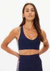 THE UPSIDE women's navy recycled peached Daytona Jetta Racerback Sports Bra is designed for a supportive fit and features removable cups. Made for yoga & pilates.