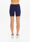 THE UPSIDE women's navy recycled peached Daytona 6 Inch Spin Short is designed for a mid-rise fit featuring contrast cream binds. Made for yoga & pilates.