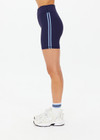 THE UPSIDE women's navy Silverstone 5 Inch Spin Short is a recycled textured rib fabrication with moisture wicking properties. Made for a soft & supportive fit in yoga and pilates.