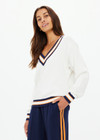 THE UPSIDE women's white organic cotton Josette V Neck Knit Sweater features a striped cable neckline in orange and navy. Made for everyday leisure.