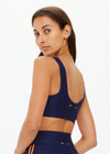 THE UPSIDE women's navy recycled fabric Oxford Harley Scoop Sports Bra is designed for a supportive fit and features removable cups. Made for high impact.