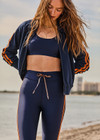 THE UPSIDE women's navy Oxford 25in Legging is designed for high impact with a breathable, moisture wicking recycled fabrication. Featuring a striped elasticated draw cord waist.