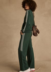 THE UPSIDE women's green Cobra Pari Zip Jacket is a true-to-size fit in a soft fabrication and features knitted stripes down sleeves. Made for everyday leisure.