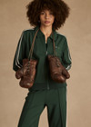 THE UPSIDE women's green Cobra Pari Zip Jacket is a true-to-size fit in a soft fabrication and features knitted stripes down sleeves. Made for everyday leisure.