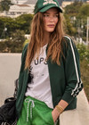 THE UPSIDE women's green Cobra Pari Zip Jacket is a true-to-size fit in a soft fabrication and features knitted stripes down sleeves. Made for everyday leisure.