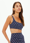 THE UPSIDE women's navy Cruzada Bridie Bra is a soft & supportive fit in a recycled jacquard rib fabrication in mini flag design and features removable cups. Made for yoga & pilates.