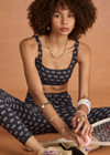 THE UPSIDE women's navy Cruzada Bridie Bra is a soft & supportive fit in a recycled jacquard rib fabrication in mini flag design and features removable cups. Made for yoga & pilates.