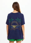THE UPSIDE women's navy organic cotton Sammi Tee is an oversized fit and features The Upside logo on front and a printed palm tree sunset design on back. Made for lifestyle.