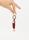 THE UPSIDE women's burgundy Limitless Keyring charm with gold metal star and macrame paracord in deep red with rubber dipped ends.