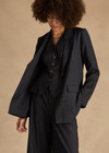 THE UPSIDE women's navy pinstripe merino Wool Boyfriend Blazer is a fully lined single breasted blazer with branded tortoiseshell buttons. Lean into a polished kind of comfort with our Wool Boyfriend Blazer.