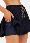 THE UPSIDE women's navy pinstripe merino Wool Cadiz Pleated Skirt features an inner short and pockets with elasticated waistband. Perfect for tennis and pickleball.