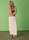 THE UPSIDE women's cream Beach Serenade Wrap Sarong is made from cotton. The beach sarong skirt features vegan leather braided belt. Designed for layering and travel.